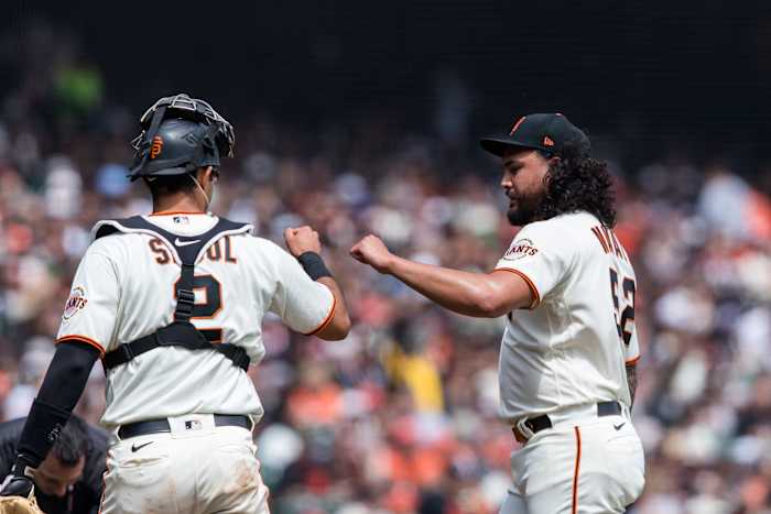 SF Giants starting pitcher Sean Manaea and catcher Blake Sabol fist-bump during a game against the Royals. (2023)