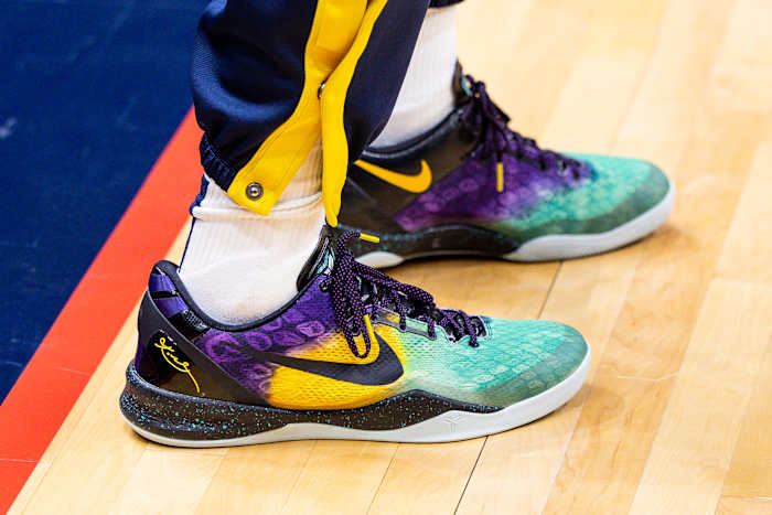 View of black, yellow, and teal Nike Kobe shoes.