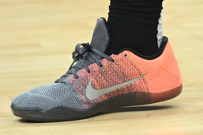 View of orange and grey Nike Kobe shoe.