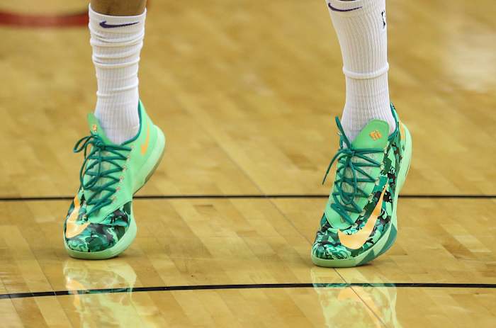 View of green and yellow Nike KD shoes.
