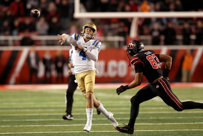 Oct 30, 2021; Salt Lake City, Utah, USA; UCLA Bruins quarterback Ethan Garbers (4) throws the ball while hurried by Utah Utes linebacker Jonah Elliss (83) in the fourth quarter at Rice-Eccles Stadium. Mandatory Credit: Rob Gray-USA TODAY Sports