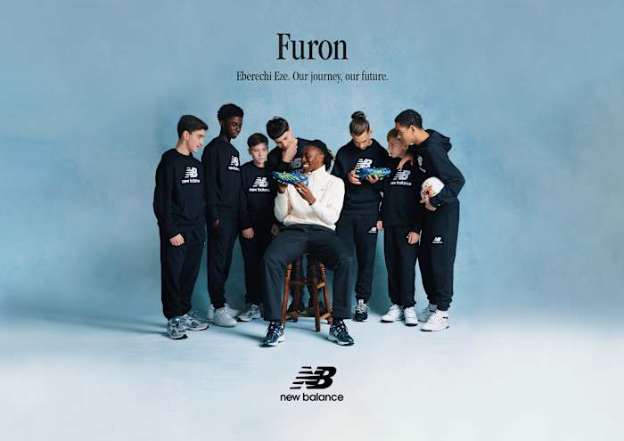 Eberechi Eze shows his soccer boot to fans.