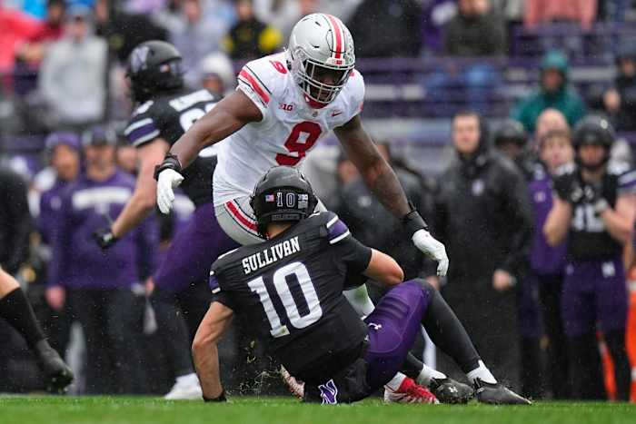 Nov 5, 2022; Evanston, Illinois, USA; Northwestern Wildcats quarterback Brendan Sullivan (10) slides down in front of Ohio State Buckeyes defensive end Zach Harrison (9) during the first half of the NCAA football game at Ryan Field. Mandatory Credit: Adam Cairns-The Columbus Dispatch Ncaa Football Ohio State Buckeyes At Northwestern Wildcats