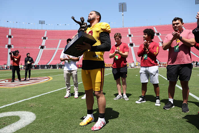 Caleb Williams holds the Heisman Trophy during the USC Trojans Spring Game.