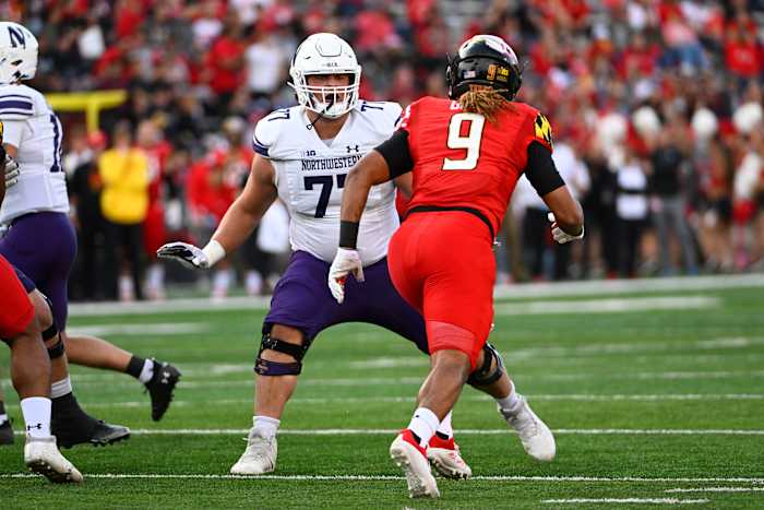 Oct 22, 2022; College Park, Maryland, USA; Northwestern Wildcats offensive lineman Peter Skoronski (77) prepares to block Maryland Terrapins linebacker Fa'Najae Gotay (9) during the first half at SECU Stadium.
