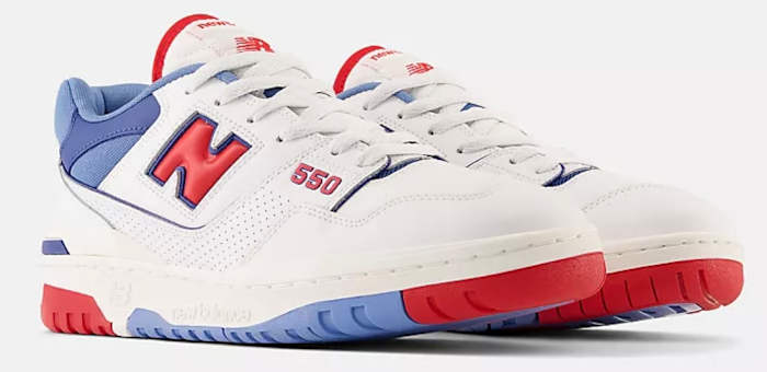 Side view of white, red, and blue New Balance shoes.