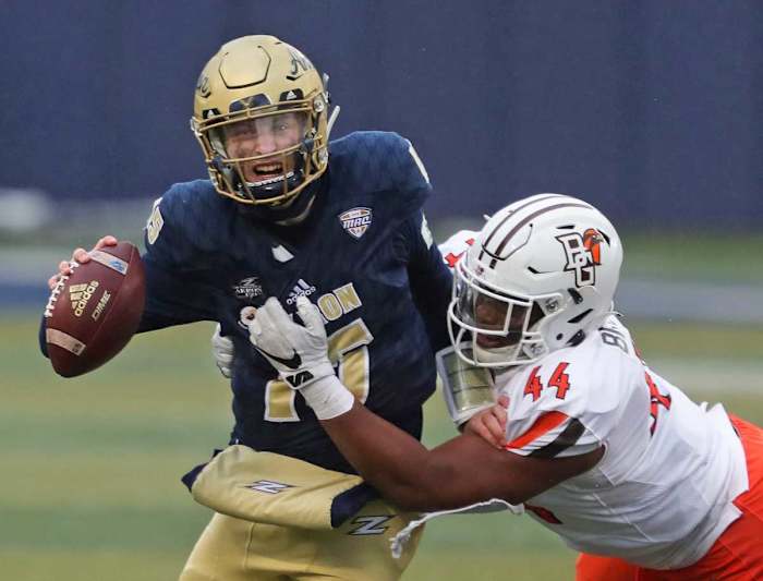 Akron quarterback Zach Gibson (15) is sacked by Bowling Green defensive lineman Karl Brooks (44) during the first half at InfoCision Stadium, Saturday, Dec. 5, 2020, in Akron, Ohio.