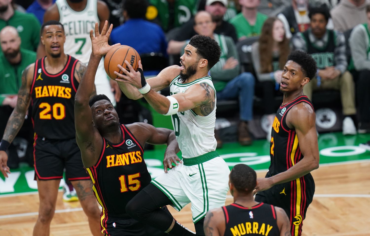 Boston Celtics forward Jayson Tatum shoots a layup over Atlanta Hawks center Clint Capela.