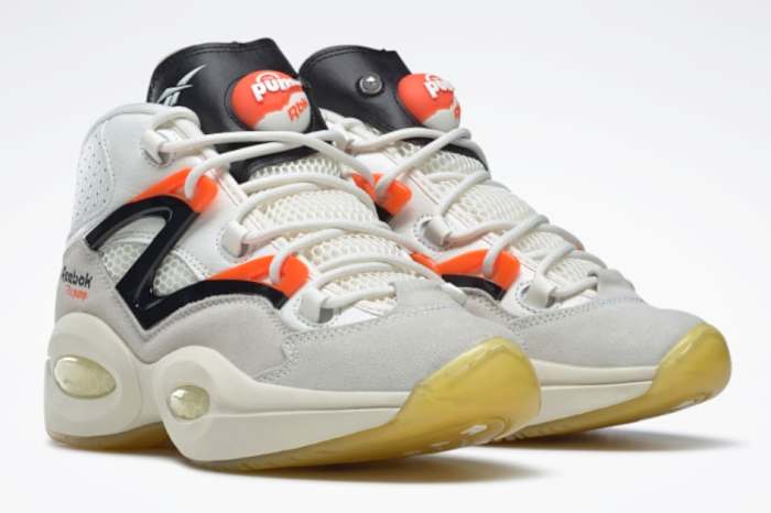 View of white, black, and orange Reebok shoes.