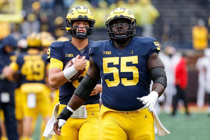 Michigan quarterback J.J. McCarthy (9) and offensive lineman Olusegun Oluwatimi (55) warm up ahead of the Maryland game at Michigan Stadium in Ann Arbor on Saturday, Sept. 24, 2022.