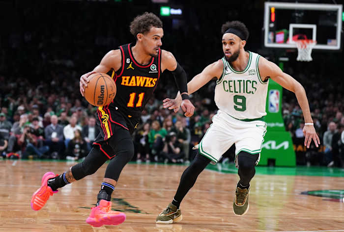 Atlanta Hawks guard Trae Young dribbles past Boston Celtics guard Derrick White.