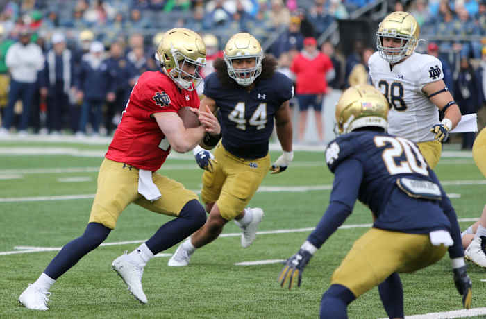 Notre Dame quarterback Sam Hartman runs with the ball.