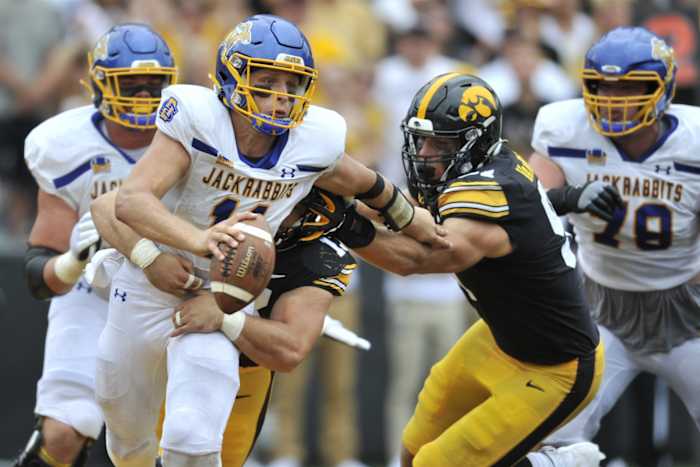 Sep 3, 2022; Iowa City, Iowa, USA; South Dakota State Jackrabbits quarterback Mark Gronowski (11) is sacked by Iowa Hawkeyes defensive end Joe Evans (13) and defensive lineman Lukas Van Ness (91) as offensive linemen Garret Greenfield (74) and Mason Richman (78) look on during the fourth quarter at Kinnick Stadium. Mandatory Credit: Jeffrey Becker-USA TODAY Sports