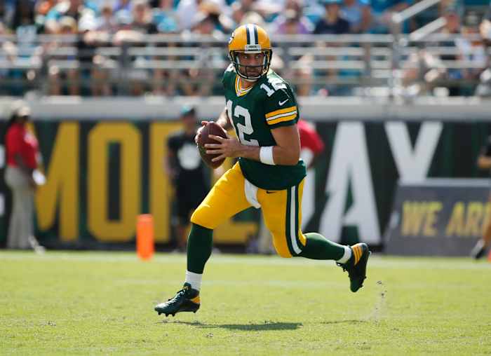 Green Bay Packers quarterback Aaron Rodgers runs with the ball.