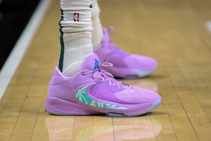 View of Giannis Antetokounmpo's purple and green Nike shoes.