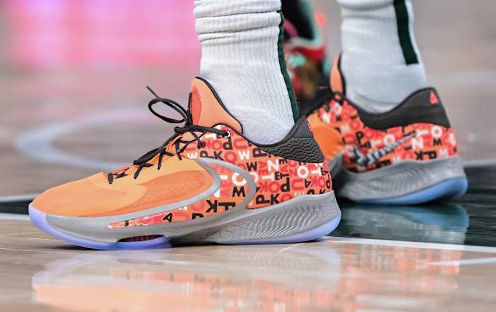 View of Giannis Antetokounmpo's orange and black Nike shoes.