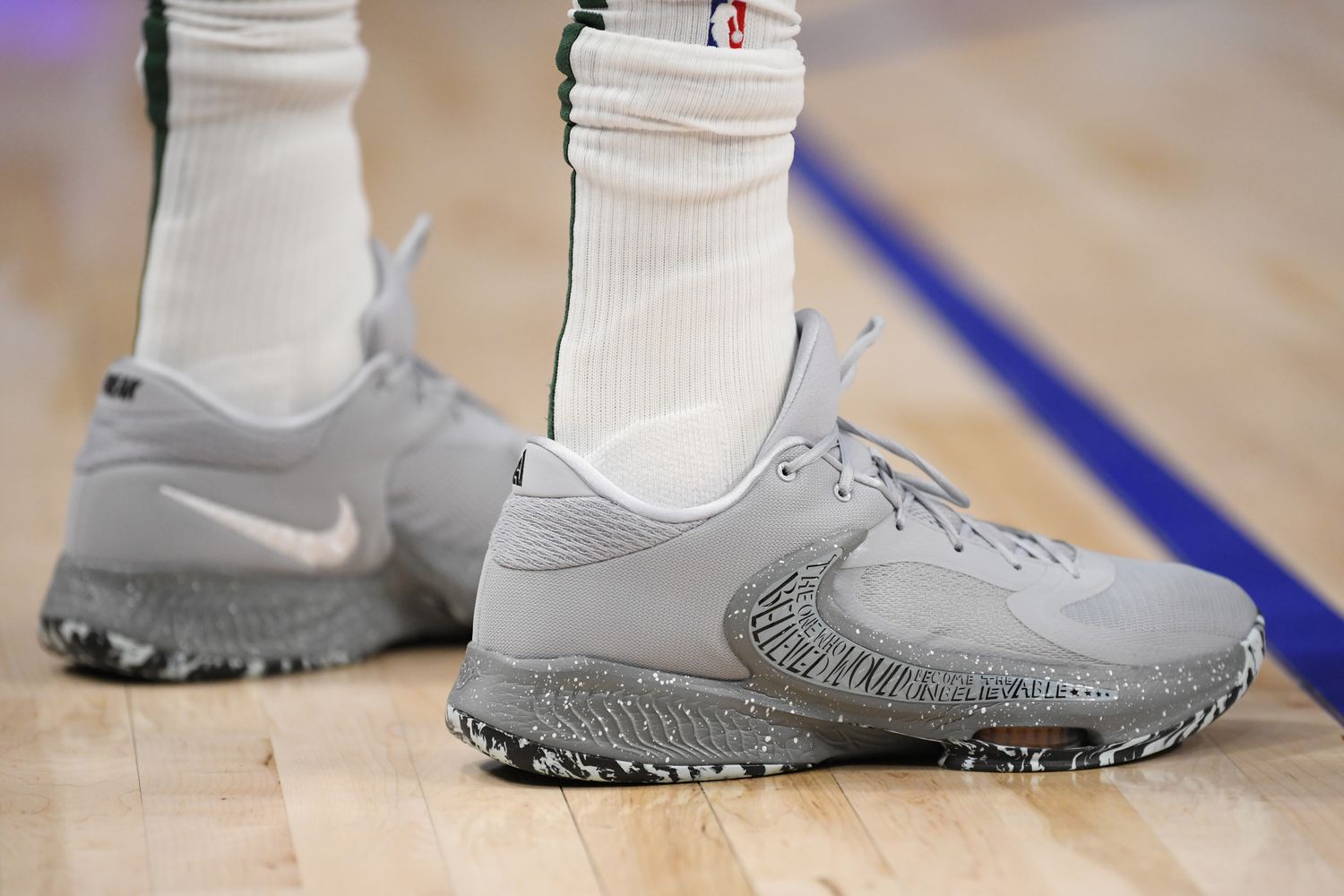 View of Giannis Antetokounmpo's grey Nike shoes.
