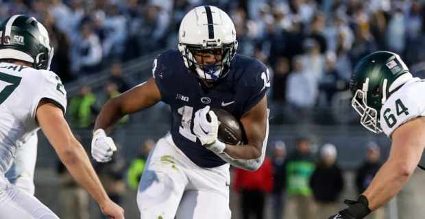 Penn State Nittany Lions running back Nicholas Singleton on a carry during a college football game in the Big Ten.