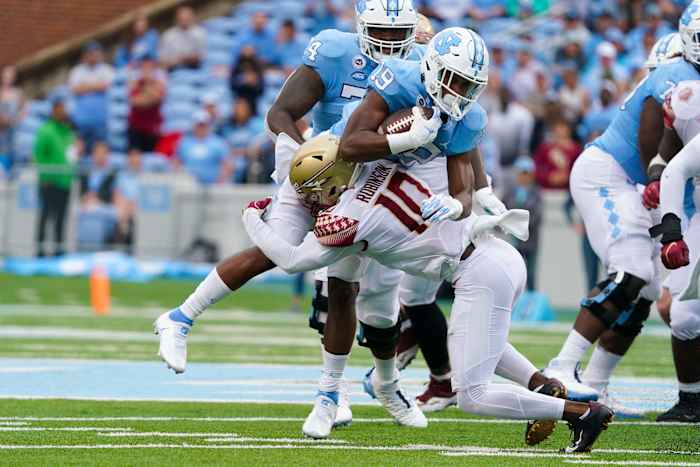 Florida State Seminoles defensive back Jammie Robinson (10) stops the run against North Carolina Tar Heels running back Ty Chandler (19) during the first half at Kenan Memorial Stadium. - James Guillory | USA TODAY Sports