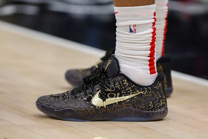 View of black and gold Nike Kobe shoes.
