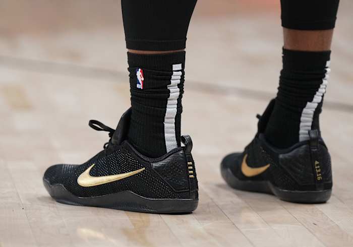 View of black and gold Nike Kobe shoes.