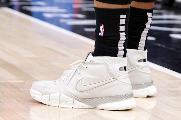 View of white and grey Nike Kobe shoes.