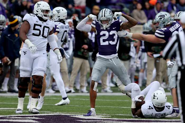 Nov 13, 2021; Manhattan, Kansas, USA; Kansas State Wildcats defensive back Julius Brents (23) celebrates the tackle of West Virginia Mountaineers running back Leddie Brown (4) during the third quarter at Bill Snyder Family Football Stadium. Mandatory Credit: Scott Sewell-USA TODAY Sports