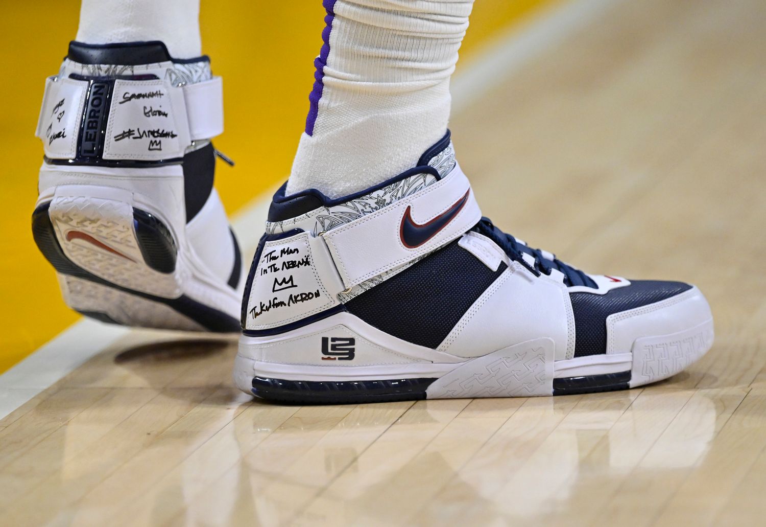 View of LeBron James' white and navy Nike shoes.