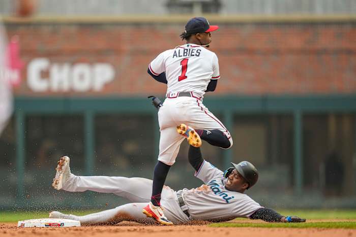 Apr 27, 2023; Cumberland, Georgia, USA; Atlanta Braves second baseman Ozzie Albies (1) forces out Miami Marlins right fielder Jesus Sanchez (7) before throwing to first base during the second inning at Truist Park.