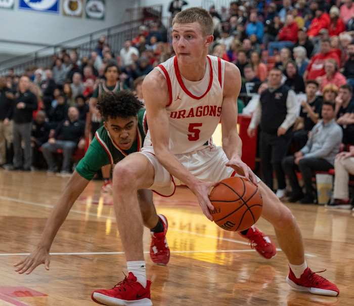 New Palestine High School's Ian Stephens (5) dribbles past a Lawrence North High School defender, at NPHS, Monday, Jan. 30, 2023, during a game won by LNHS, 59-58.