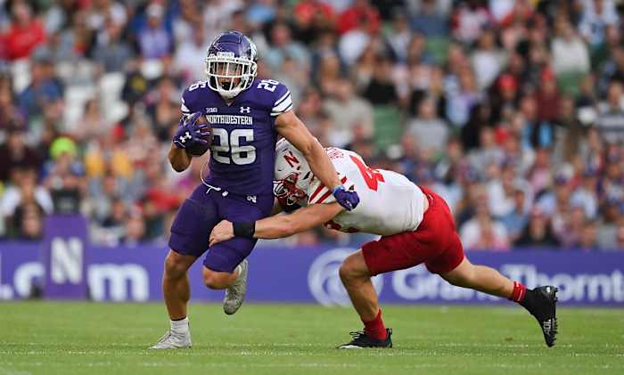 Aug 27, 2022; Dublin, IRELAND; Northwestern Wildcats running back Evan Hull is tackled by Nebraska Cornhuskers linebacker Nick Henrich in the Aer Lingus college football series at Aviva Stadium. Mandatory Credit: Brendan Moran-USA TODAY Sports
