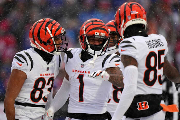 Cincinnati Bengals wide receiver Ja'Marr Chase (1), center, is congratulated by Cincinnati Bengals wide receiver Tyler Boyd (83), Cincinnati Bengals running back Joe Mixon (28) and Cincinnati Bengals wide receiver Tee Higgins (85) after a touchdown catch in the first quarter during an NFL divisional playoff football game between the Cincinnati Bengals and the Buffalo Bills, Sunday, Jan. 22, 2023, at Highmark Stadium in Orchard Park, N.Y. Cincinnati Bengals At Buffalo Bills Afc Divisional Jan 22 0190