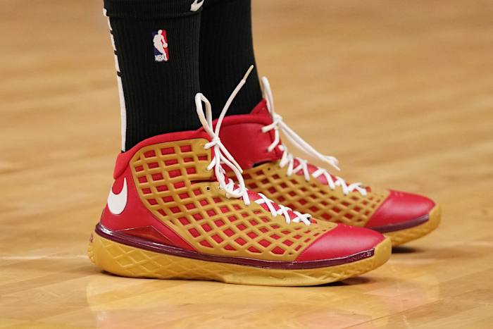 View of red and gold Nike Kobe shoes.