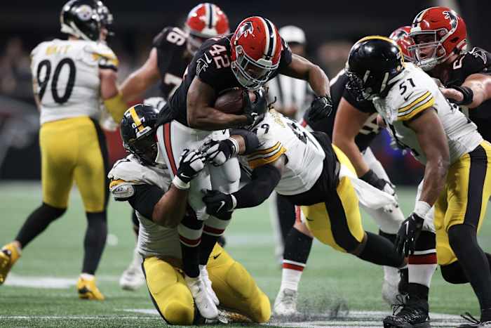 Dec 4, 2022; Atlanta, Georgia, USA; Atlanta Falcons running back Caleb Huntley (42) is tackled by Pittsburgh Steelers defensive tackle Cameron Heyward (97) and defensive tackle Larry Ogunjobi (99) in the second half at Mercedes-Benz Stadium. Mandatory Credit: Brett Davis-USA TODAY Sports