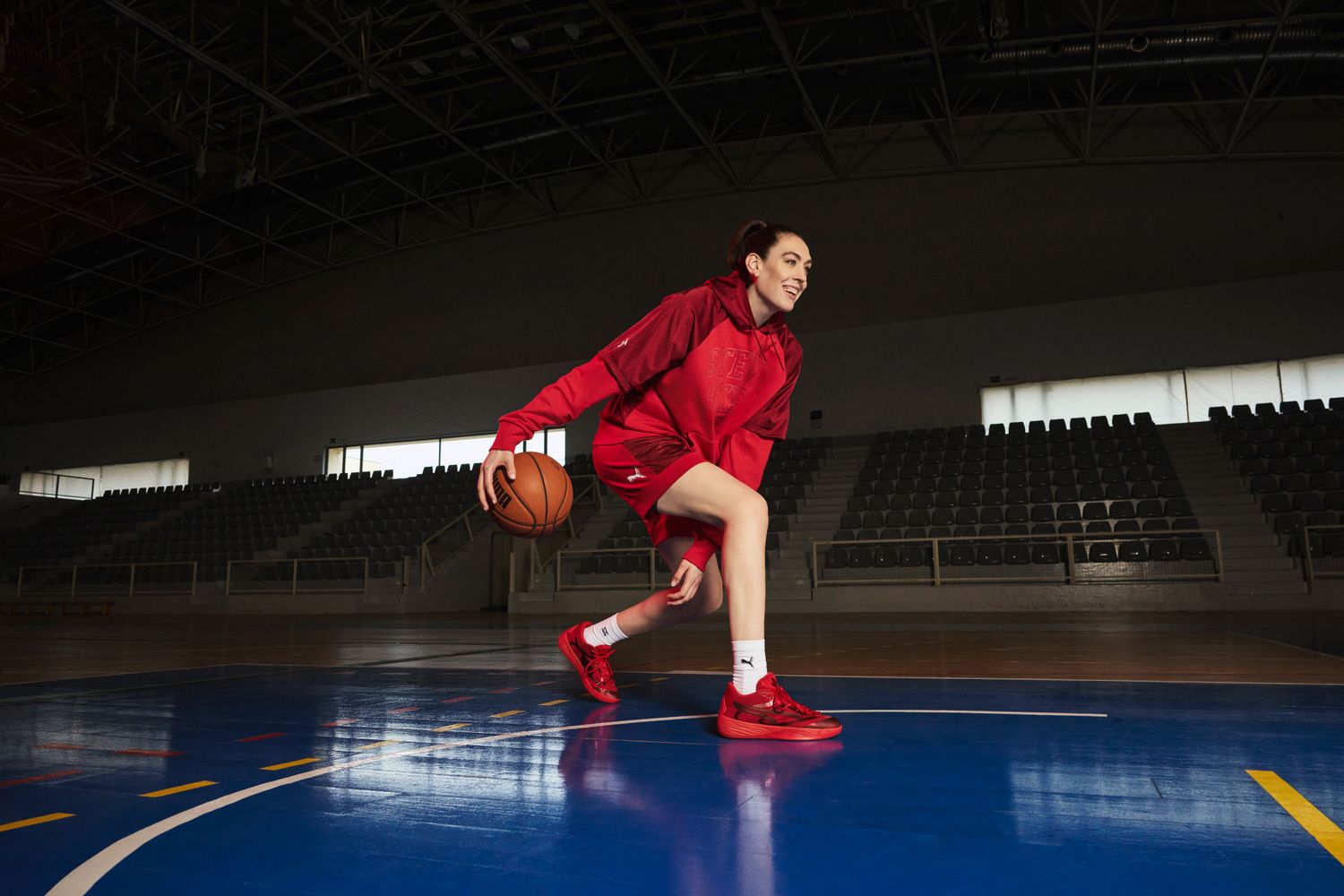 Breanna Stewart plays basketball in red Puma shoes.
