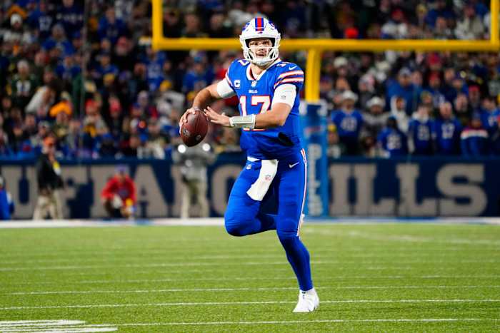 Bills' quarterback Josh Allen looks to throw on the run in a 2022 SNF game