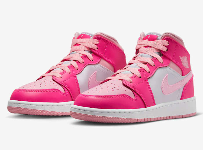 Side view of pink and white Air Jordan shoes.