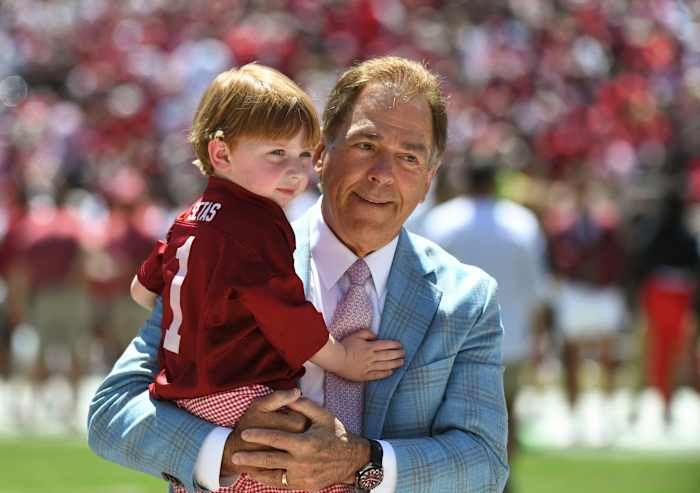 Alabama head coach Nick Saban holds his grandson before the A-Day game at Bryant-Denny Stadium.