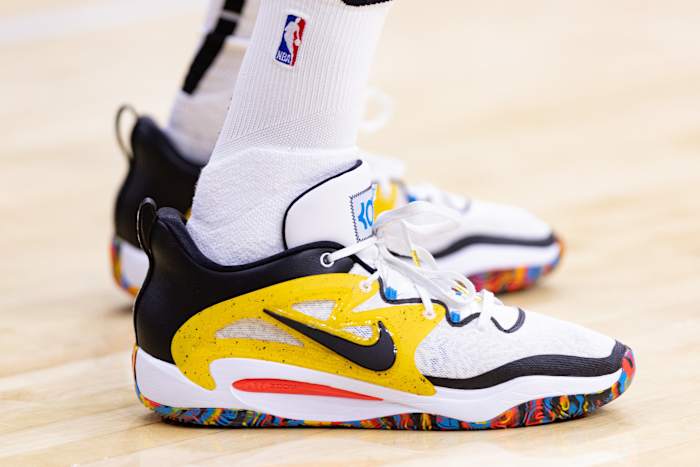 View of Kevin Durant's white, black, and yellow Nike shoes.