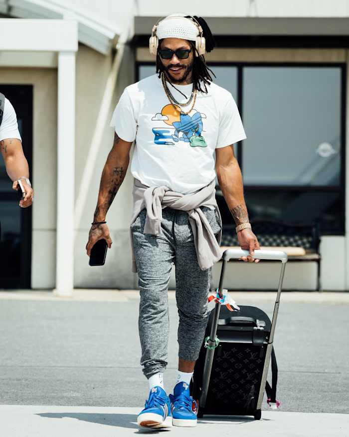 Derrick Rose carries his suitcase to the team plane.