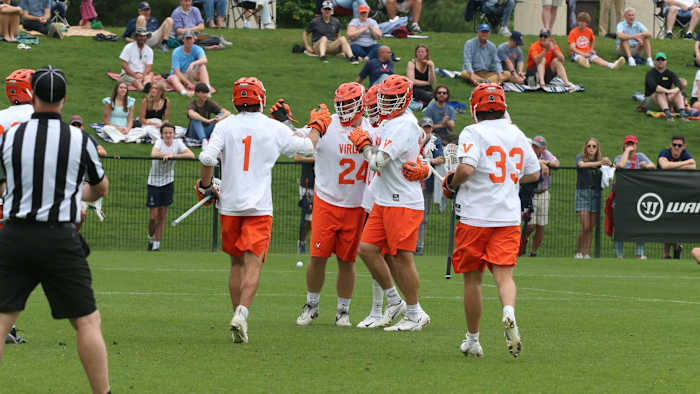 The Virginia men's lacrosse team celebrates after scoring a goal against Richmond in the first round of the NCAA Men's Lacrosse Championship at Klockner Stadium.