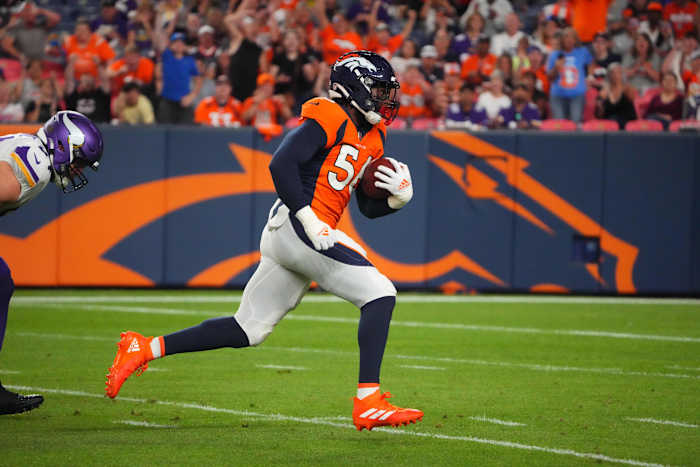 Aug 27, 2022; Denver, Colorado, USA; Denver Broncos linebacker Baron Browning (56) runs for a touchdown after picking up a fumble in the second quarter against the Minnesota Vikings at Empower Field at Mile High.