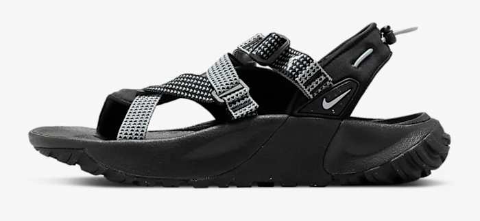 Side view of black Nike sandals.