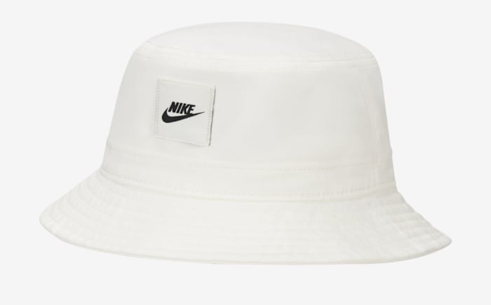 View of white and black Nike bucket hat.