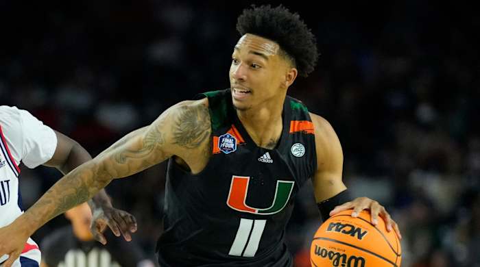 Miami guard Jordan Miller drives the ball