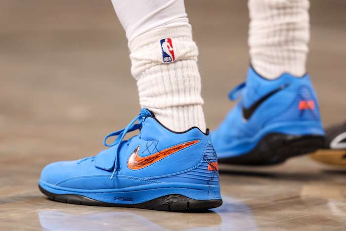 View of Kyrie Irving's blue and black Nike shoes.