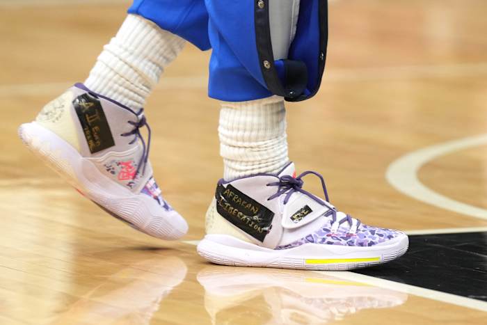 View of Kyrie Irving's purple Nike shoes.