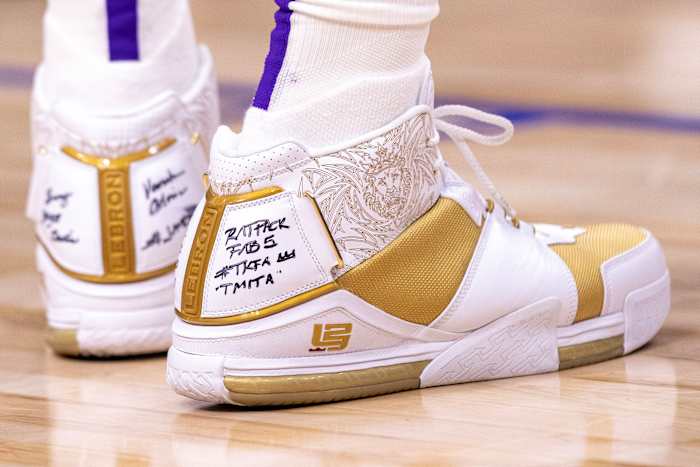 View of LeBron James' white and gold Nike shoes.
