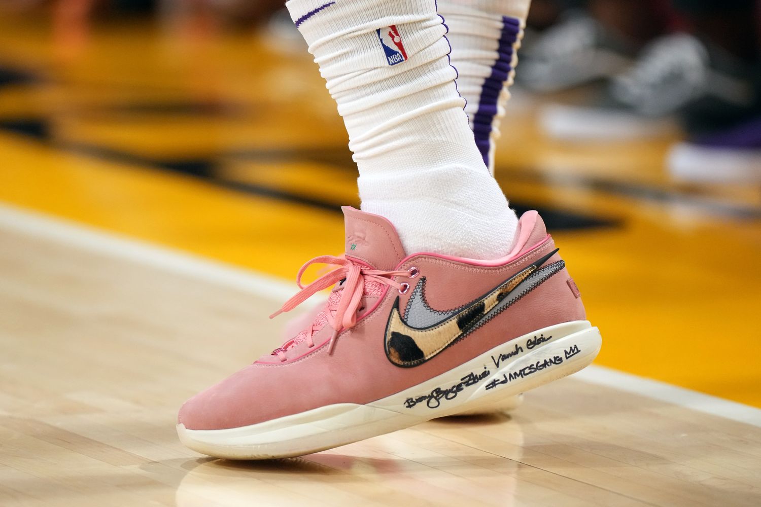 View of LeBron James' pink and white Nike shoes.