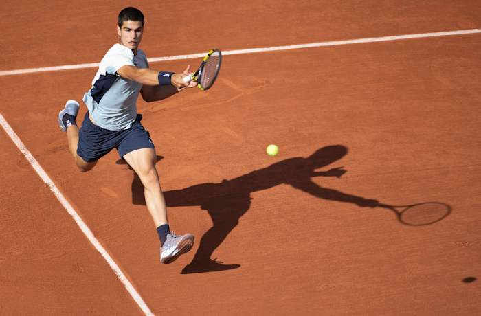 Carlos Alcaraz returns a shot from the baseline.